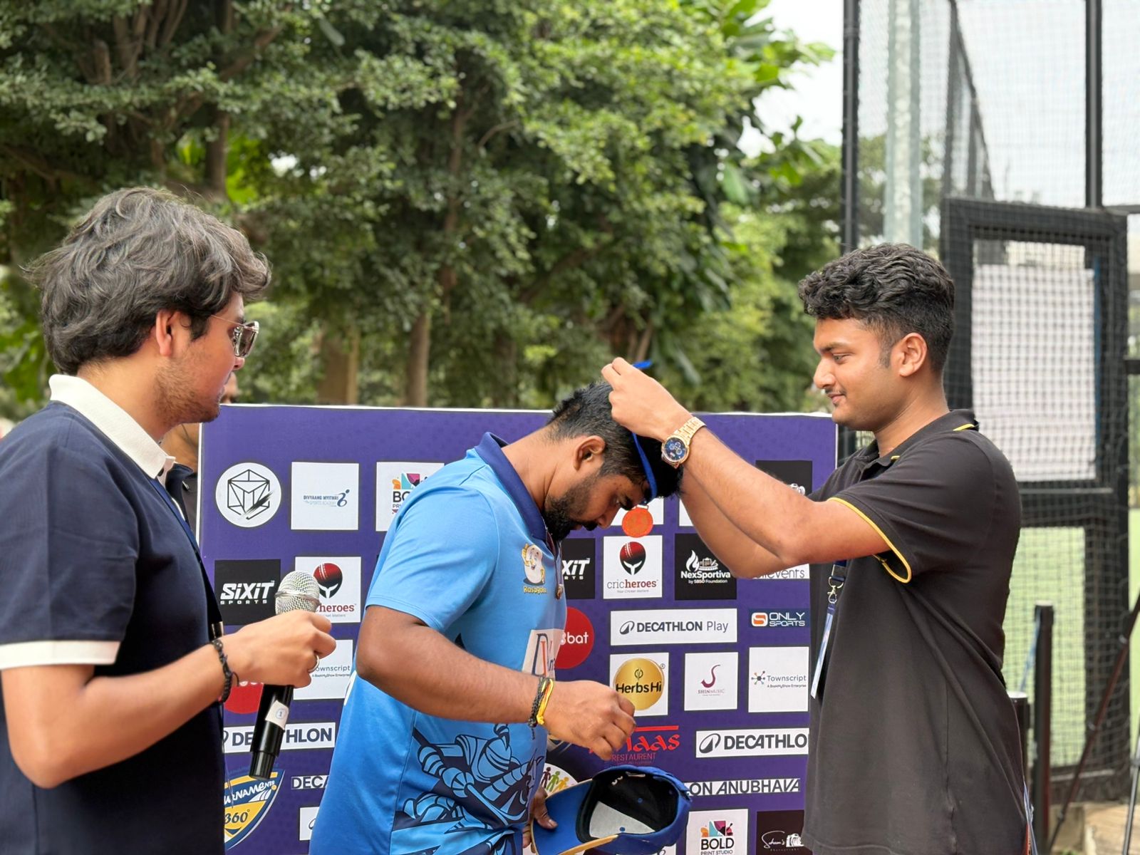 Fans in pink paraphernalia posing at the fan zone